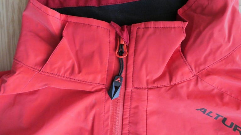 Close-up of the large zip puller and collar of the Altura Nightvision Thunderstorm Jacket.