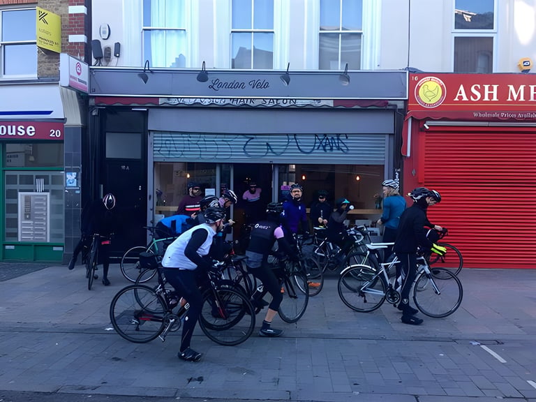 Cyclists with road bikes gather outside the London Velo café in Deptford, where the festival gravel ride departs.