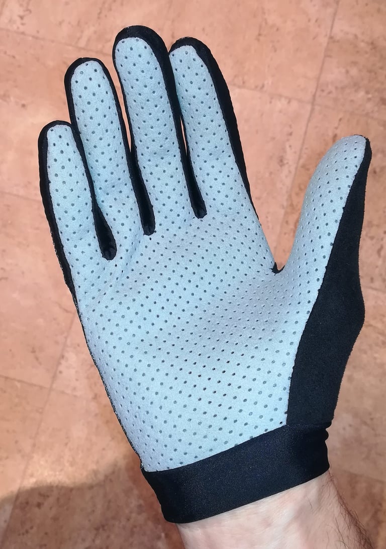 Palm of the Alpkit Comet glove worn on a hand, showing the perforated synthetic leather and short cuff.