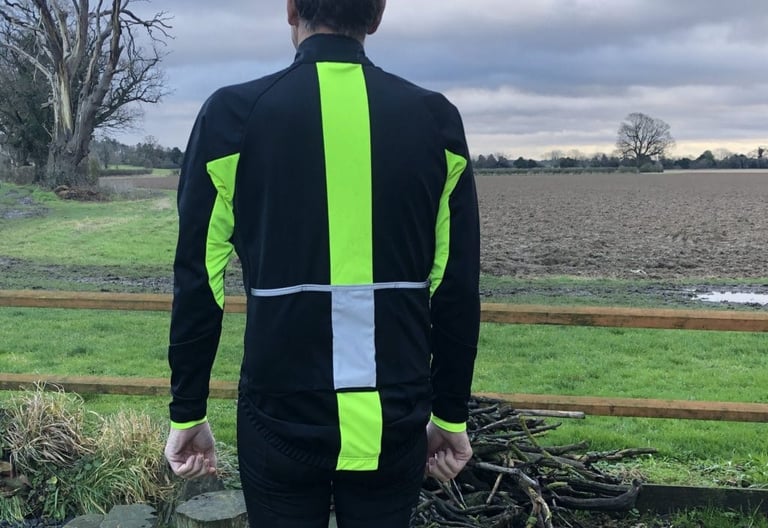 Rear of the Galibier Mistral jacket, with a hi-vis yellow stripe down the back, a reflective panel and yellow arm panels.