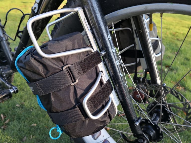 Close-up of a Passport Cycles Lug-Kage holding a bag with two velcro straps on a Surly Moonlander fork blade.