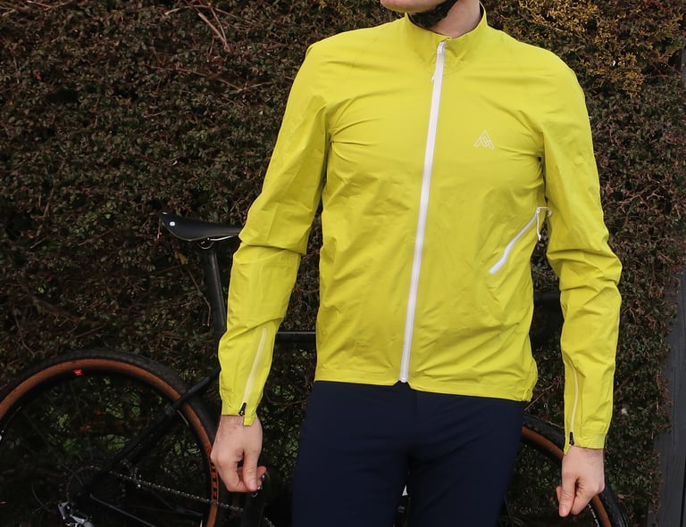 Front of the neon yellow 7Mesh Rebellion jacket with white centre zip, cuff zips and side pocket vent.