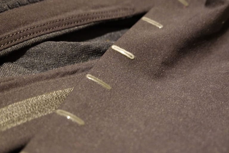 Close-up of the silicone gripper dashes and band along the hem of the 7Mesh Mission Jersey.