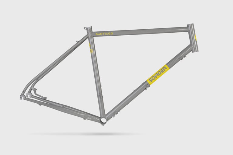 Bare grey Sonder Santiago steel frame with yellow logos, mudguard and rack mounts, and a post-mount disc tab.