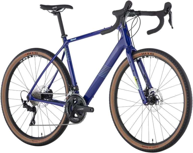 Blue Salsa Warroad 105 with Shimano 105 groupset and tan-wall 650b x 47c tyres on white.