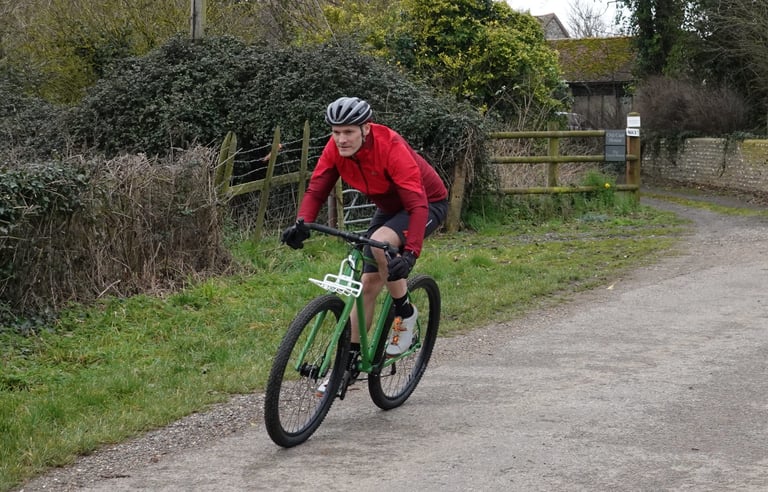 The green Mason InSearchOf ridden out along a country lane past hedges and a gate, heading for the South Downs.
