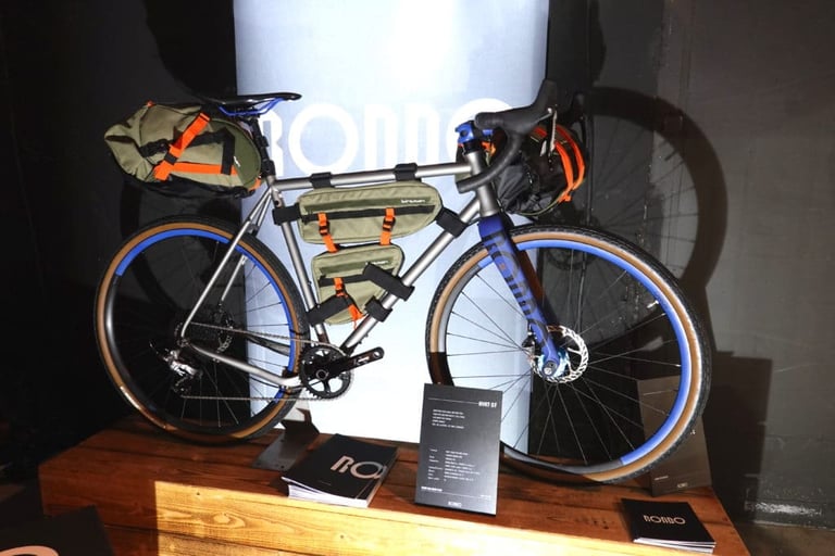 Rondo Ruut ST gravel bike loaded with Birzman bikepacking bags, blue rims and tan-wall tyres on display.