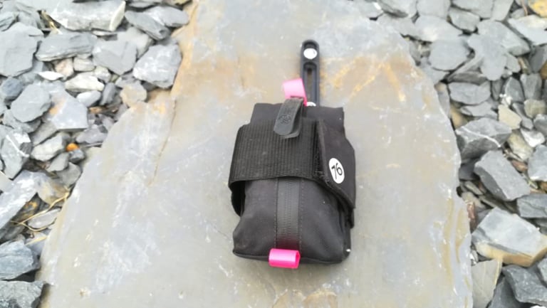 76 Projects Piggy bracket with Piggy Pouch strapped on, seen from above on a slate slab.