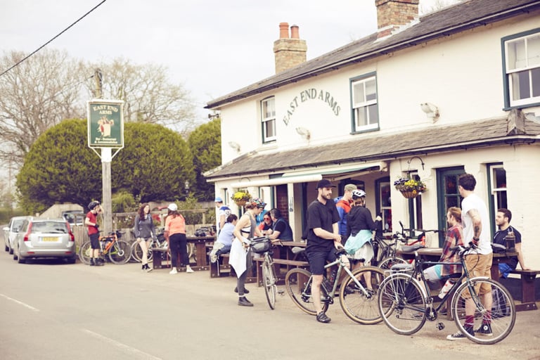 Riders and bikes gathered at tables outside the East End Arms pub during a Brother in the Wild ride.