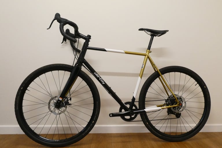 Non-drive side of the All City Cosmic Stallion with Genetic Driser bars, full length against a plain wall.