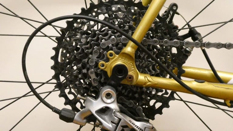 SRAM wide-range cassette and rear derailleur at the gold dropout of the All City Cosmic Stallion.