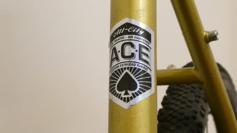 All City ACE custom extruded tubing decal on the gold seat tube of the Cosmic Stallion.
