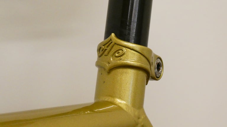 Gold All City seat collar with AC monogram where the black seatpost meets the Cosmic Stallion frame.