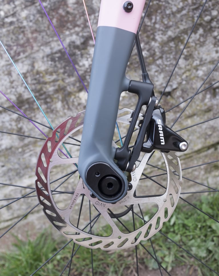 Rondo Ruut carbon fork dropout showing the geometry flip chip, with a SRAM flat-mount brake caliper and rotor.