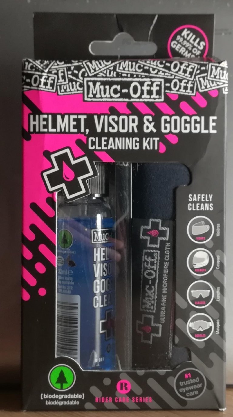 Boxed Muc-Off Helmet, Visor and Goggle Cleaning Kit containing a cleaning fluid bottle and microfibre cloth.