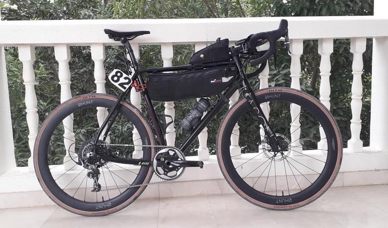 Josh Ibbett's Mason Definition with Miss Grape frame and top tube bags and race number 82, set up for BikingMan Oman.