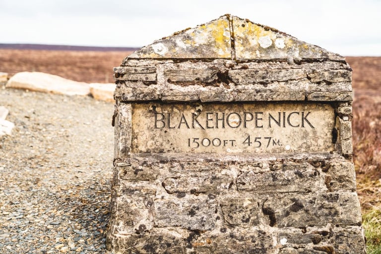 Stone marker reading Blakehope Nick, 1500 ft, 457 m, beside the gravel route at Dirty Reiver 2019.