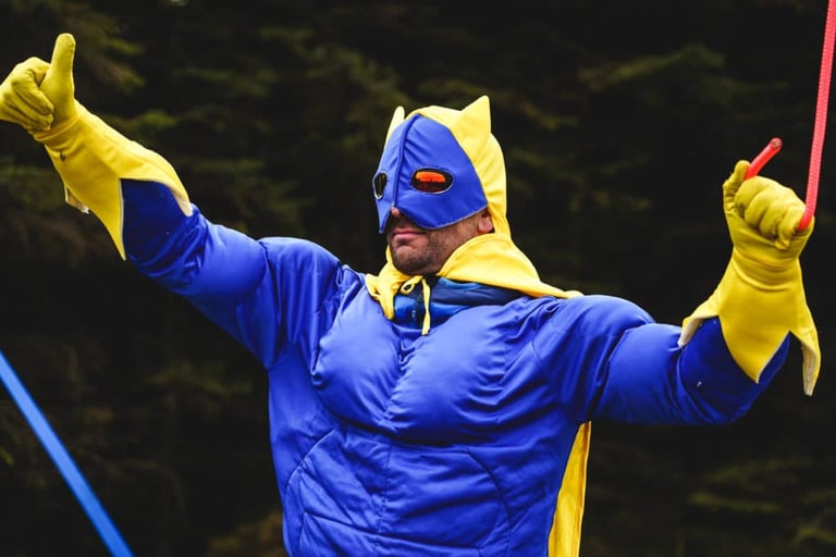 Banana Man in a blue and yellow costume gives two thumbs up in the forest at Dirty Reiver 2019.