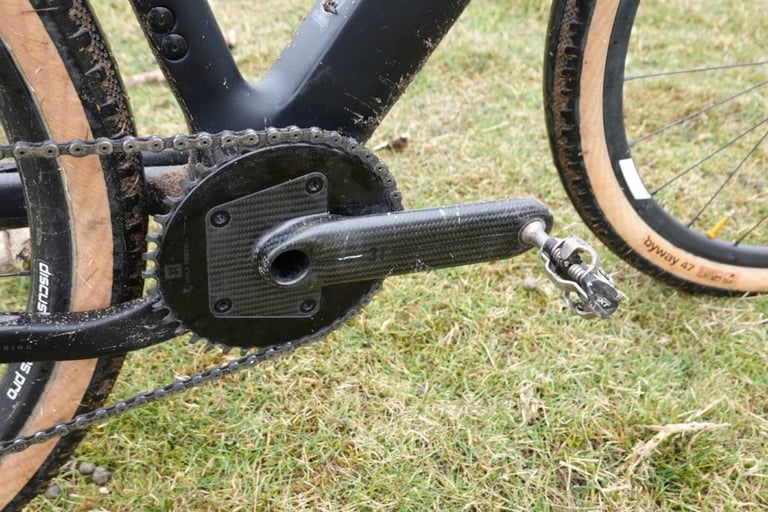 3T Torno carbon crank and chainring on the Exploro LTD, with a mud-spattered frame and pedal.