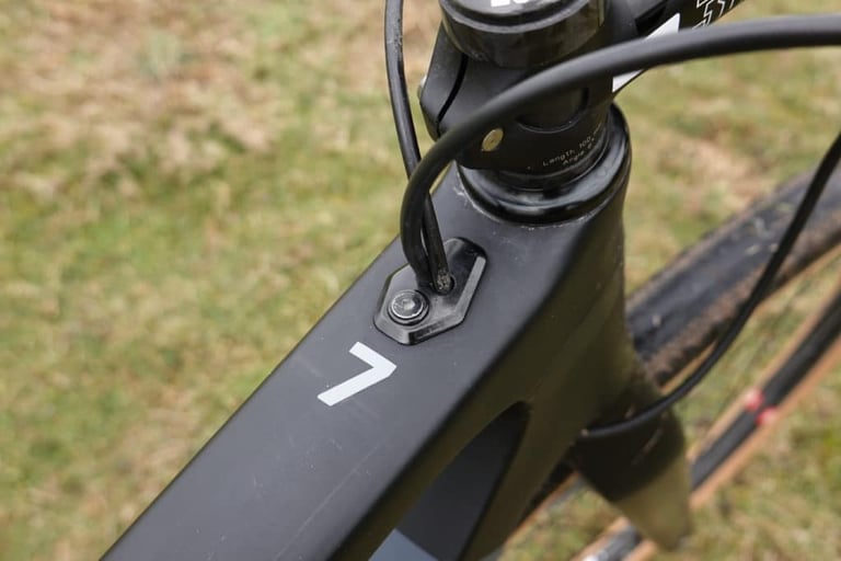 3T Exploro top tube behind the stem, with a cable entering the frame through a port beside a white 7 decal.