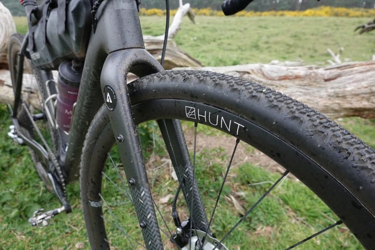 Hunt 30 Carbon Gravel front wheel and muddy tyre on the Bombtrack Hook EXT-C, chosen for the Dirty Reiver.