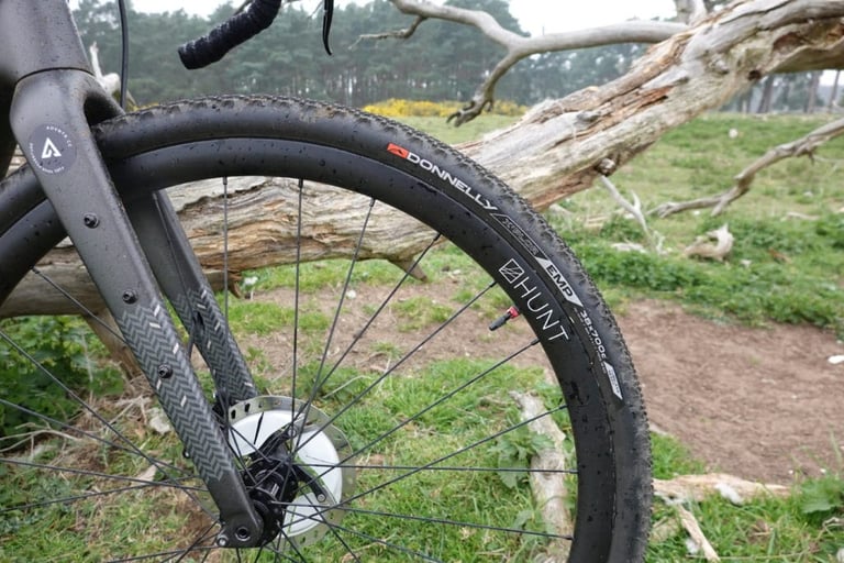 Donnelly EMP 700x38 tyre on a Hunt carbon rim, front wheel of the Bombtrack Hook EXT-C, with fork and brake rotor.