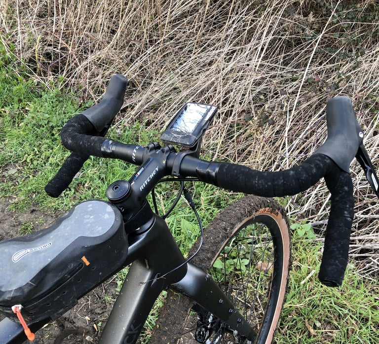 Top-down view of Ritchey WCS VentureMax bars on a Bombtrack Hook EXT-C with a GPS mount, wrapped in black tape.