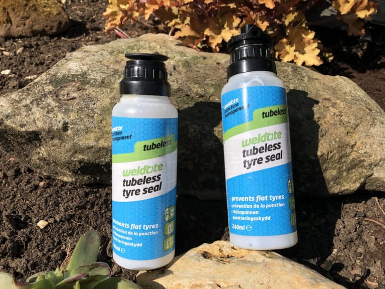 Two Weldtite Tubeless Tyre Seal bottles, their flip-top caps hiding the filler tube and valve core tool.