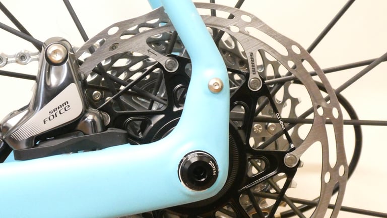 SRAM Force hydraulic disc brake caliper and thru axle at the rear dropout of the Orbea Terra.
