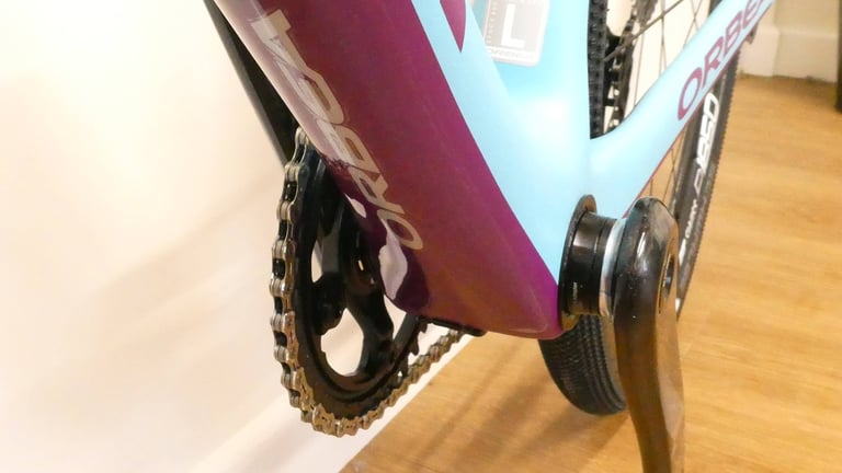 Underside of the Orbea Terra's purple down tube, seen from low down beside the chainring and crank arm.