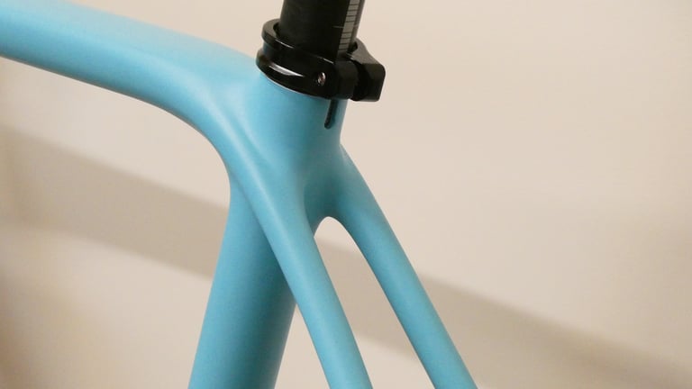 Slim, curved seatstays of the Orbea Terra's pale blue carbon frame meeting the seat tube below the seatpost clamp.