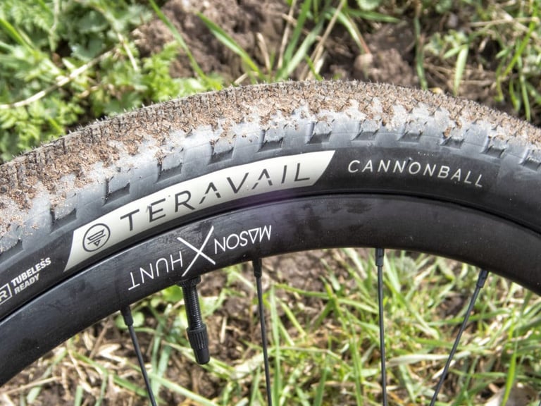 Teravail Cannonball tyre on a Mason x Hunt 650 Adventure Sport rim, with the tread caked in dry mud.