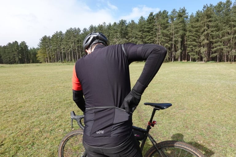 Rider reaches into a rear pocket of the Gore C5 Gore-Tex Infinium softshell jersey.
