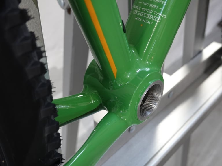 Close-up of the larger Ø56 bottom bracket shell on a green Mason Bokeh 2 frame, with the rear tyre alongside.