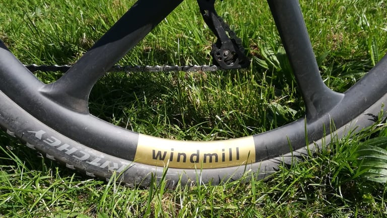 Merit Windmill rim logo in black on a gold decal, with a Ritchey tyre alongside.