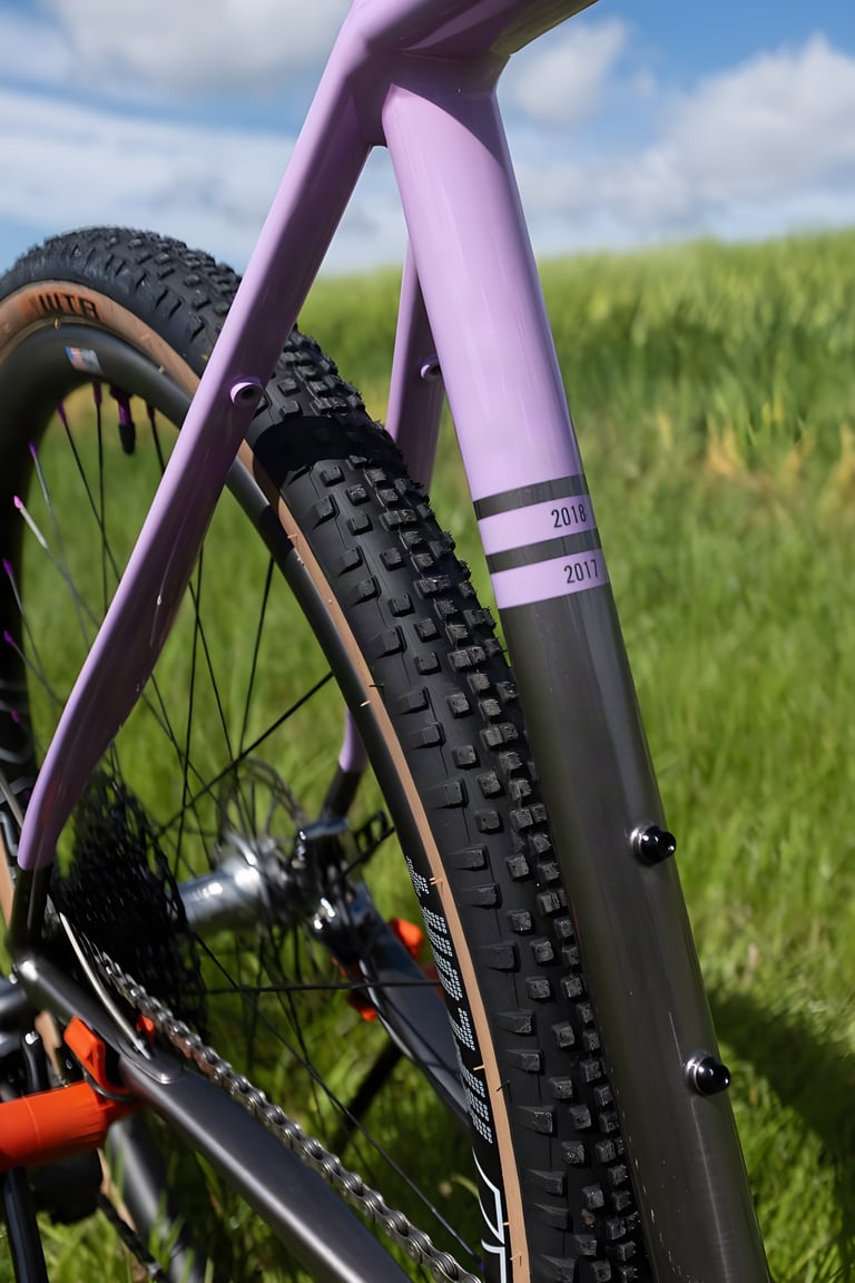 Seat tube stripes marking 2017 and 2018 Grinduro class wins on the lilac and grey Cannondale Slate.