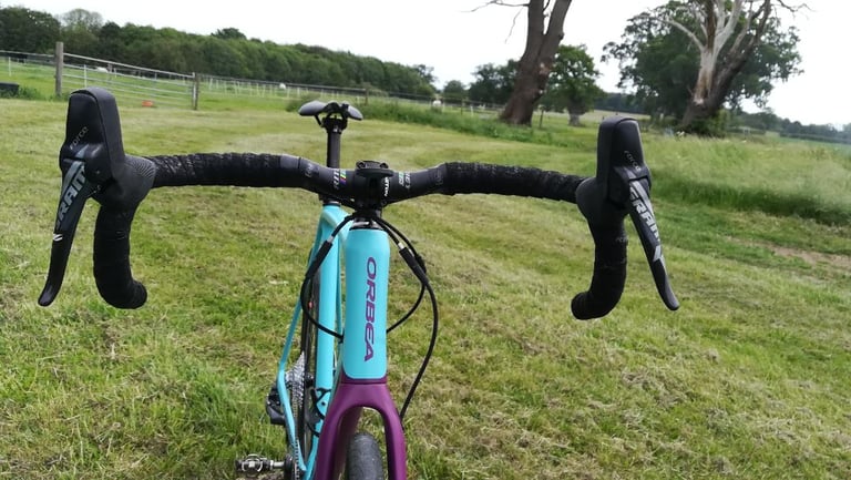 Front view of the Ritchey WCS Ergomax bar with SRAM Force levers, showing its subtle flare, on a turquoise Orbea.