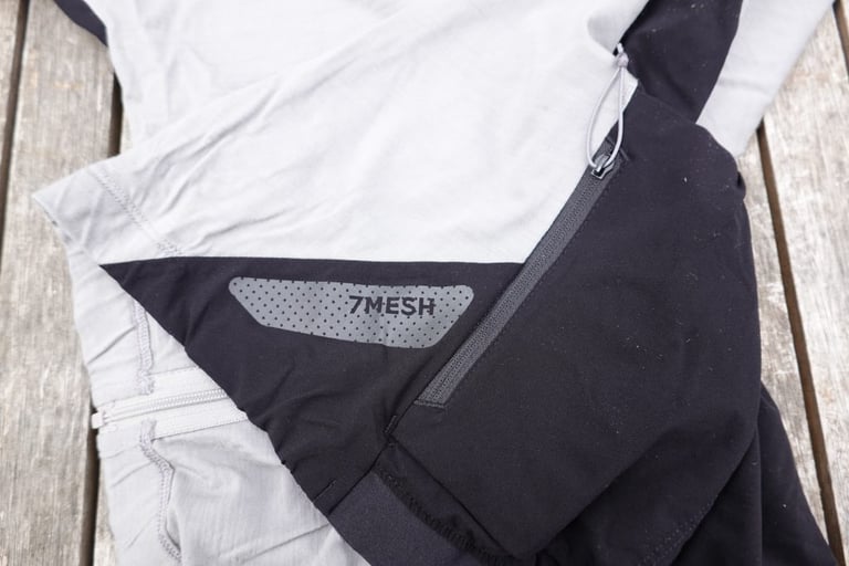 Reflective 7Mesh panel and zipped side pocket low on the side of the grey and black Ashlu jersey.