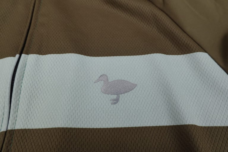 Blackmore duck logo in silver-grey on the pale chest stripe of the Cadet jersey.