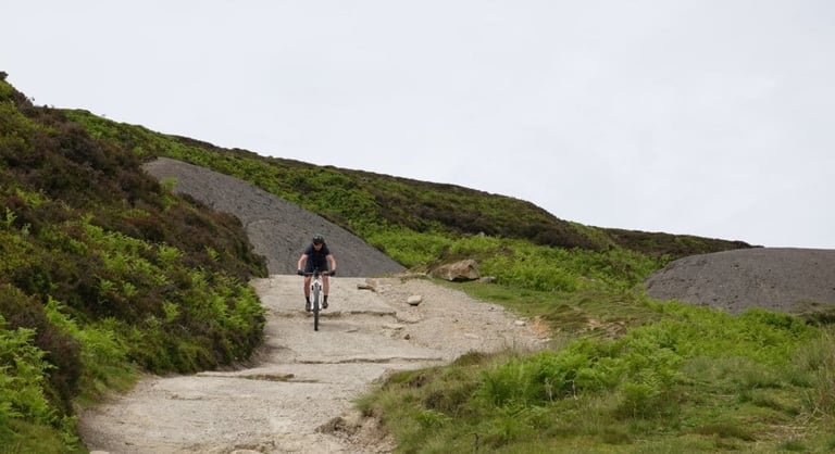 Rider descends a rocky moorland track in North Yorkshire during testing of Squirt tyre sealant.