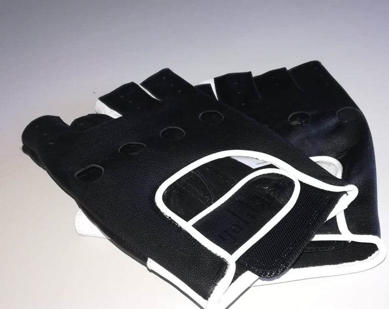 Galibier Ginettaccio mitts back side up, showing black perforated leather with white piping and a velcro tab.