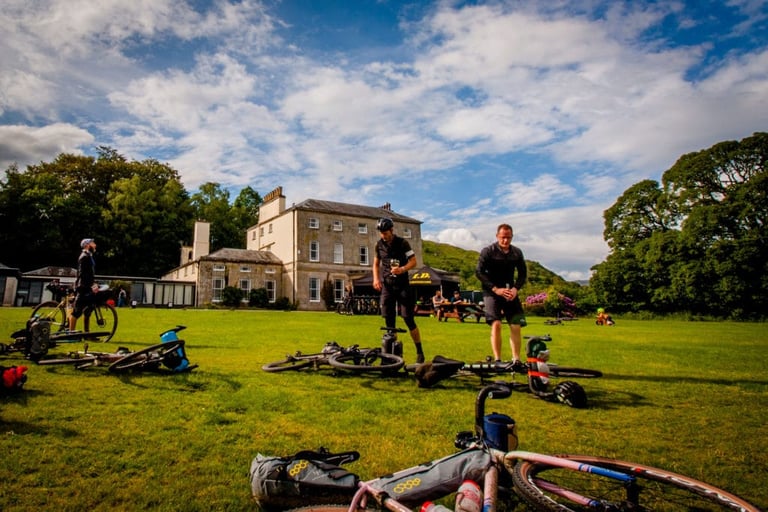 Loaded bikes lie on the front lawn of Brathay Hall as riders unpack for The Distance overnight camp.