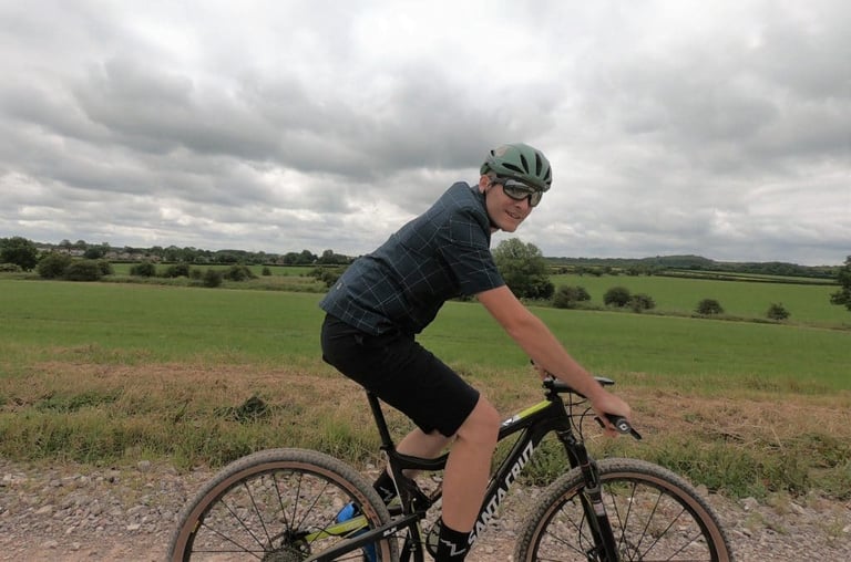 Side view of a rider on a Santa Cruz mountain bike, the Overland shirt billowing in the wind.