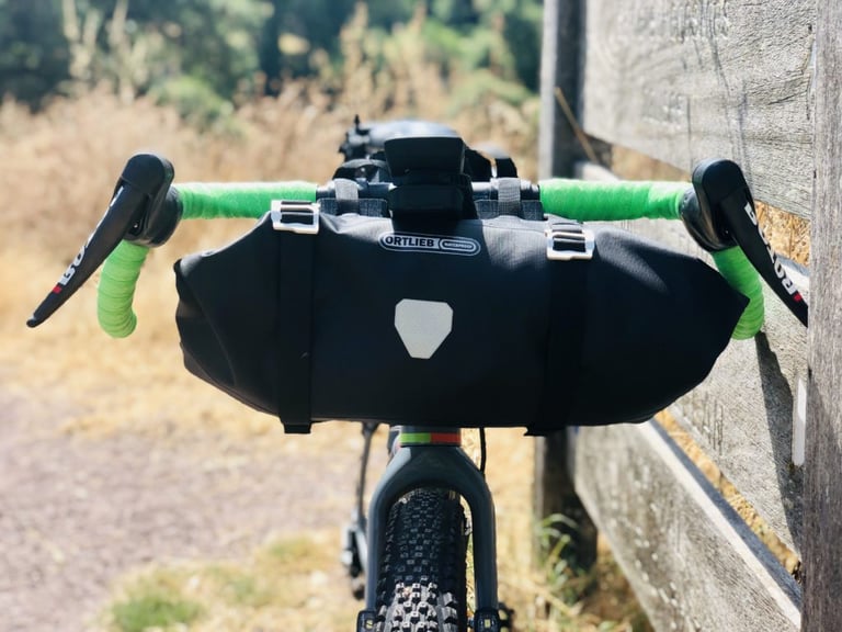 Ortlieb waterproof handlebar bag on the OPEN WI.DE, with green bar tape and ROTOR levers.