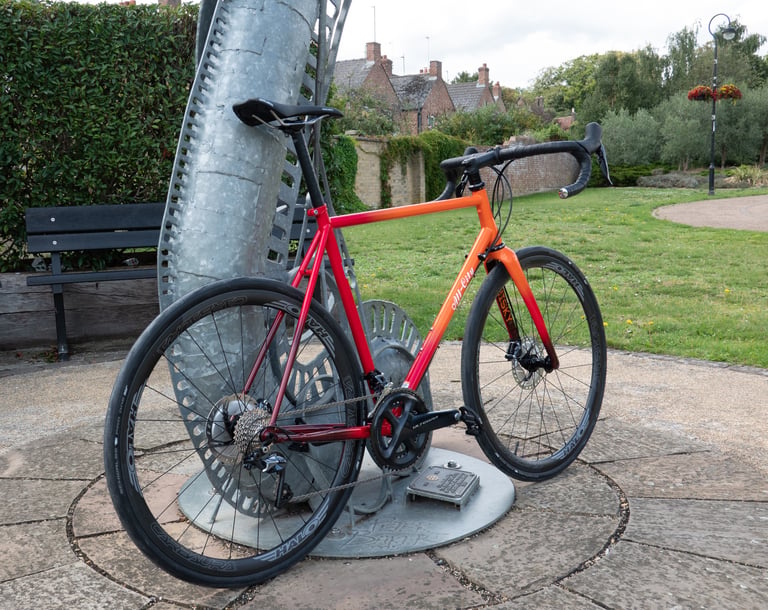Drive-side view of the All City Zig Zag in rum punch paint with Ultegra cranks and Halo Carbaura wheels.