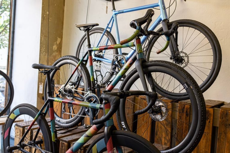 Gravel bikes with colourful patterned frames on display in the 8bar Bikes showroom in Berlin.
