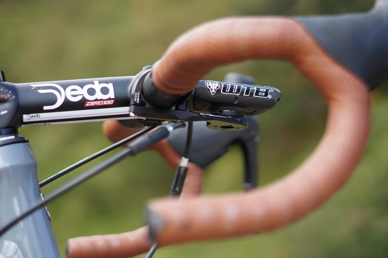 Long, slammed 140mm Deda Zero100 stem with a WTB computer mount on James Heaton's Trek Crockett, brown tape beyond.