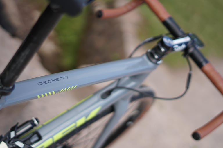 Crockett 7 branding on the top tube of James Heaton's Trek gravel bike, with a Deda stem and brown bar tape behind.
