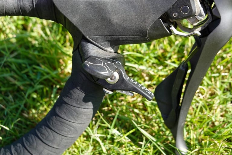 PRO Discover Dropper Lever close-up, showing its square-edged alloy paddle beside the bar tape and brake lever.