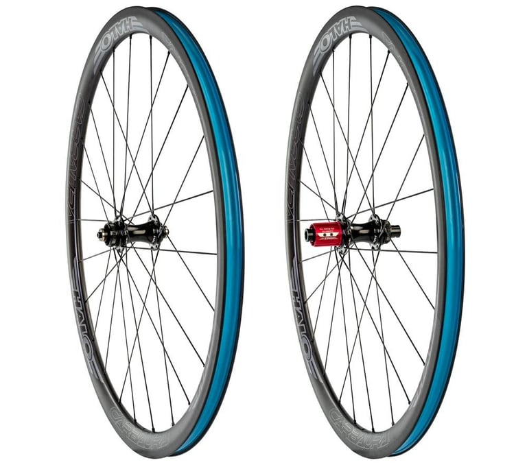 Halo Carbaura RCD carbon disc wheelset, front and rear wheels with blue rim tape and a red freehub, on white.